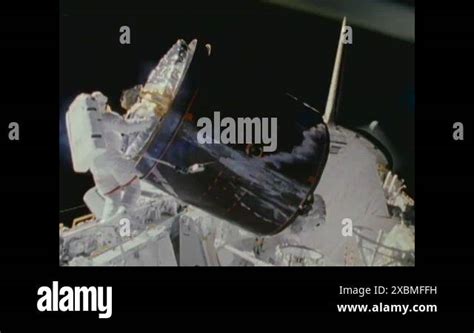 Astronauts Torque Two Satellites To The Payload Bay Of The Space