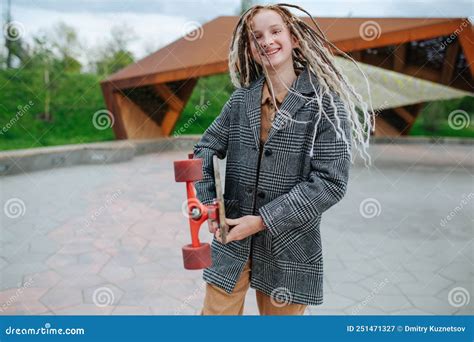 Pumped Smiling Teenage Girl With Dreads Holding A Skate In A Park Stock Image Image Of