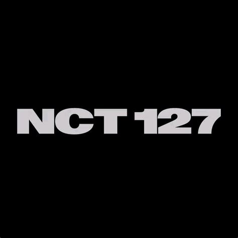 The Logo For Nct 1227 Is Shown In Black And White On A Dark Background