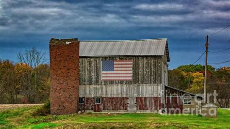 A Beautiful Amish Barn Adorned With A Flag Painting In New Wilmington