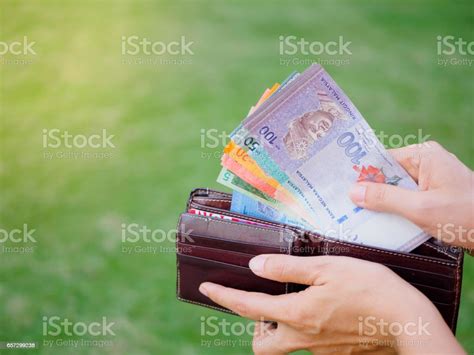 Hands Taking Out Money Malaysia Ringgit From Wallet On The Green Grass