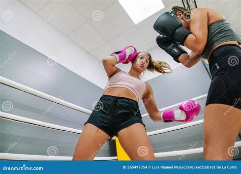 Female Boxer Throwing A Low Blow To Her Opponent In A Boxing Practice