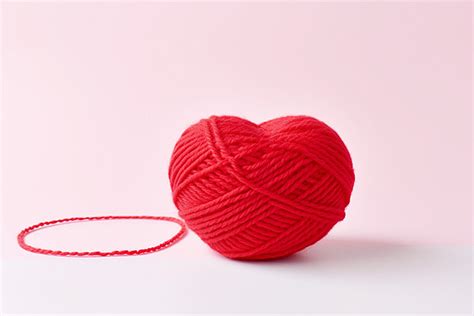 Red Ball Of Yarn And Thread On White Surface Background Winter Season