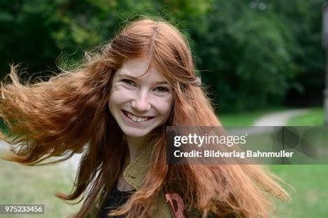 Teenage Girl With Long Red Hair Flicking Her Hair Germany High Res