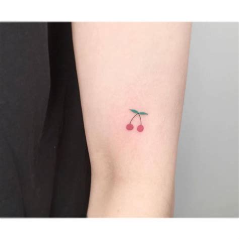 Minimalist Cherry Tattoo On The Upper Arm