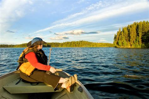 Woman fishing by boat stock image. Image of trees, patience - 17010103