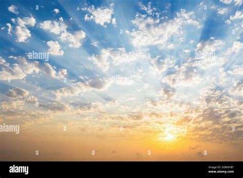 Beautiful blue sky with clouds, sunset and sunbeams Stock Photo - Alamy