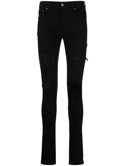 Amiri Ripped Knee Logo Print Skinny Jeans In Black Modesens