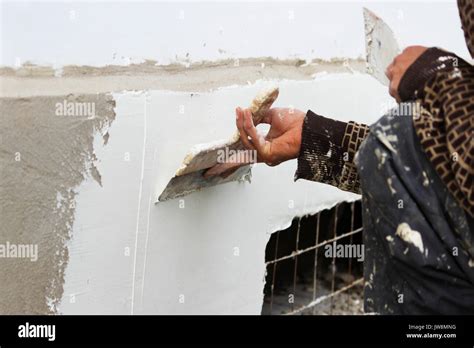 Construction Worker Plasterer With Wall Plastering Tools Renovating