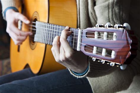 How to Hold a Guitar - Proper Posture and Hand Positioning - GUITARHABITS