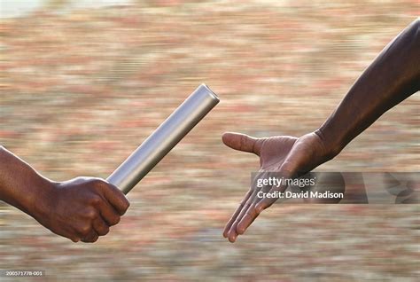 Baton Hand Over In Relay Race Closeup High Res Stock Photo Getty Images