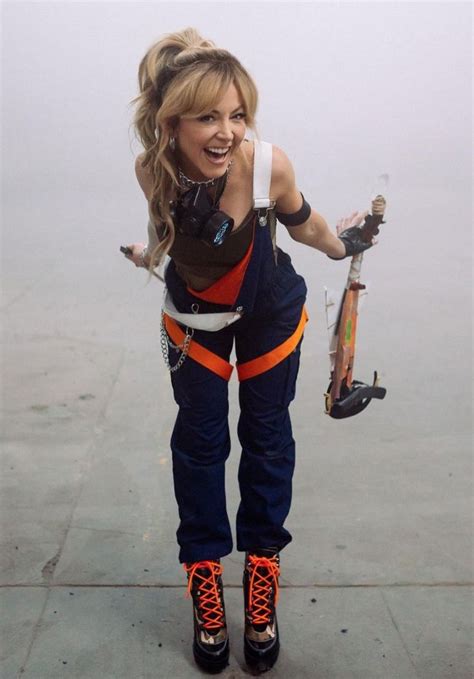 a woman is posing with her skateboard in the air while wearing rollerblades