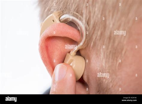 Close Up Of Man Wearing Hearing Aid In Ear Stock Photo Alamy