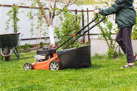 Lawn Mover On Green Grass In Sunny Day Lawn Mover On Green Grass In Modern Garden Stock Image