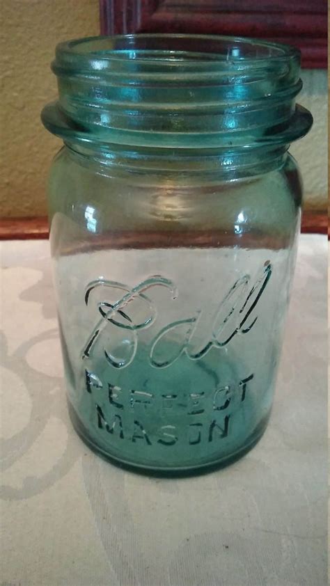 There Is A Glass Jar With Some Writing On It