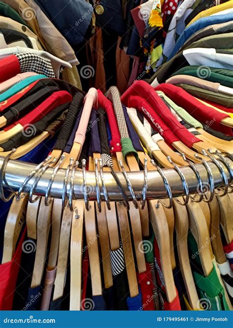 Colorful Apparel on Hangers Hanging on a Circle Iron Rail in a Clothing Store for Display Stock ...