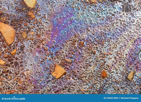 Colorful Fuel And Oil On An Asphalt Texture Showing Heavy Enviromental