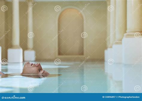 Woman Floating In Swimming Pool Stock Image Image Of Daydreaming