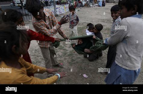 Pakistani kids playing in slums of Lahore, Pakistan on Friday, Oct. 29 ...