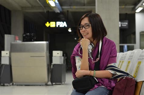 Premium Photo Portrait Of Smiling Mid Adult Woman Sitting On Chair