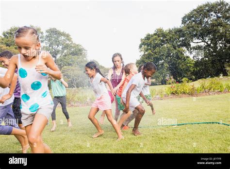 Kids playing together during a sunny day Stock Photo - Alamy