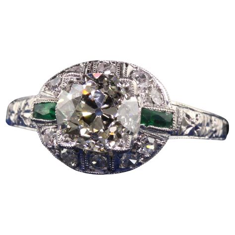 Antique Art Deco Platinum Emerald Cut Diamond Emerald Halo Engagement