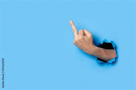 Hand Shows The Gesture Of The Middle Finger On A Blue Background Offensive Gesture Fuck Off