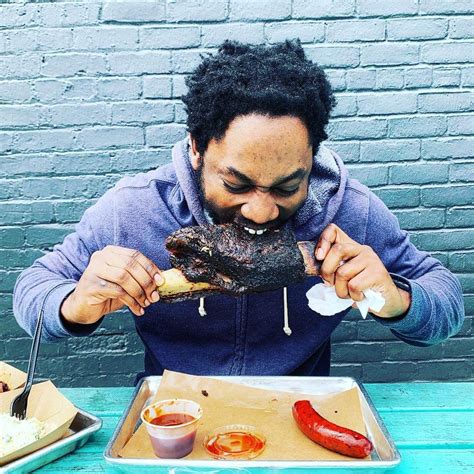 Person Eating A Large Piece Of Barbecue At Heim Bbq In Fort Worth