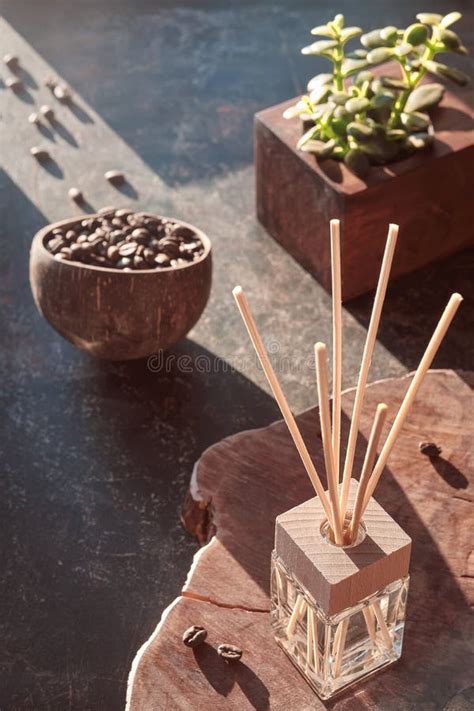 Air Freshener With Bamboo Sticks With Perfume In Glass On Dark Textured