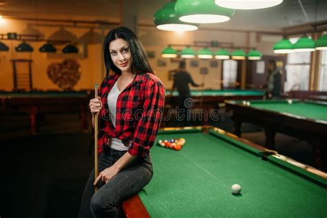 Female Billiard Player With Cue Poses At The Table Stock Photo Image