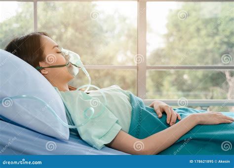 Asian Woman Patient On Bed In Hospital With Wearing Oxygen Mask Stock