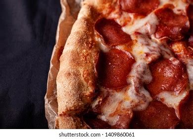 Pizza Peperoni On Black Stone Background Stock Photo