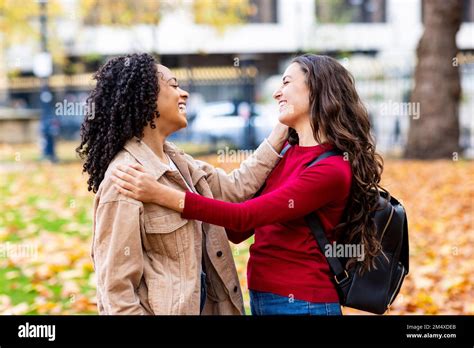 Happy Friends Talking In Autumn Park Stock Photo Alamy