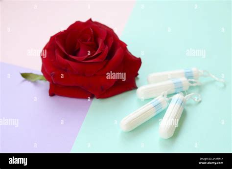 Menstrual Pads And Tampons And Red Rose Flower On Multicolored Background Aspects Of Women