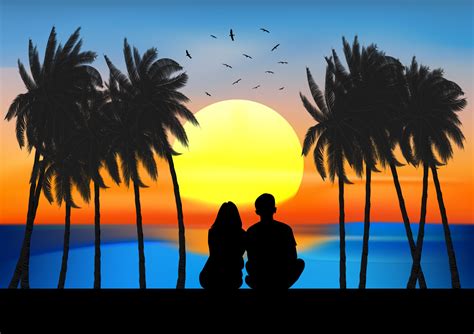 Couple Sitting On Beach Sunset