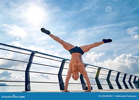 Young Man Is Doing Street Workout Handstand Exercise Bodyweight Stock