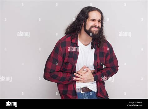 Portrait Of Sick Handsome Man With Beard And Black Long Curly Hair In Casual Style Checkered