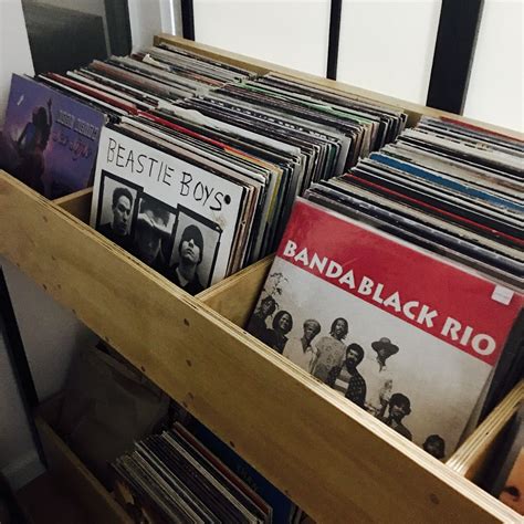 several records are stacked on top of each other in a wooden drawer ...