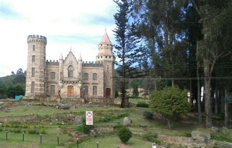 an old castle like building in the middle of a park with lots of trees ...