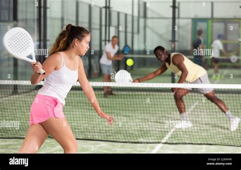 Woman playing padel tennis on padel court Stock Photo - Alamy