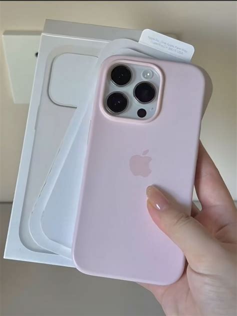 A Person Holding An Iphone Case In Their Hand Next To Two Boxes With