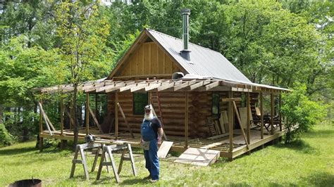 Off Grid Log Cabin Build Wrap Around Porch Metal Roof Installation