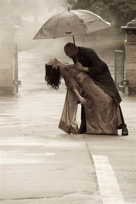 Indian Couple Kissing Under An Umbrella In The Rain Ki Stock Photo