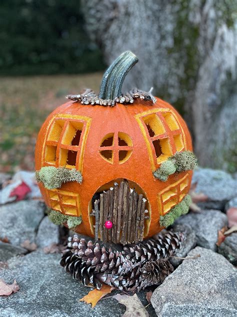 Carve a pumpkin to look like a charming cottage, with a twig door and ...