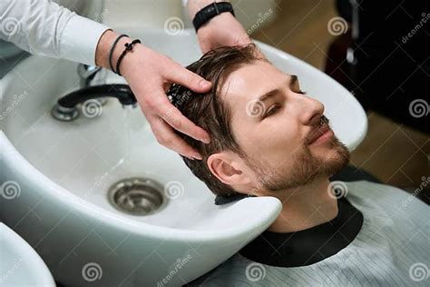 Hairdressing Salon Client Enjoys The Process Of Washing Hair Stock