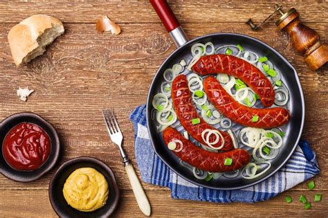 Fried Sausages in a Pan with Onions Stock Photo - Image of roasted ...