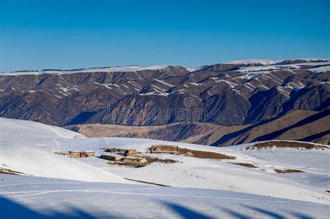 Small Wooden Hut At The Foot Of The Snow Covered Tianshan Mountains In