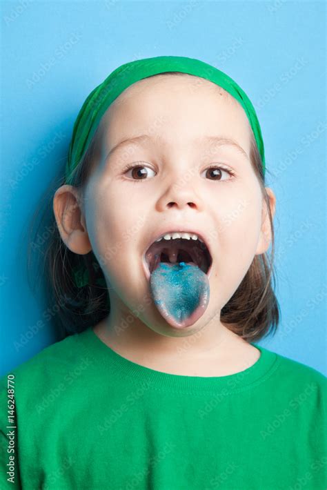 Little girl with blue tongue Stock Photo | Adobe Stock