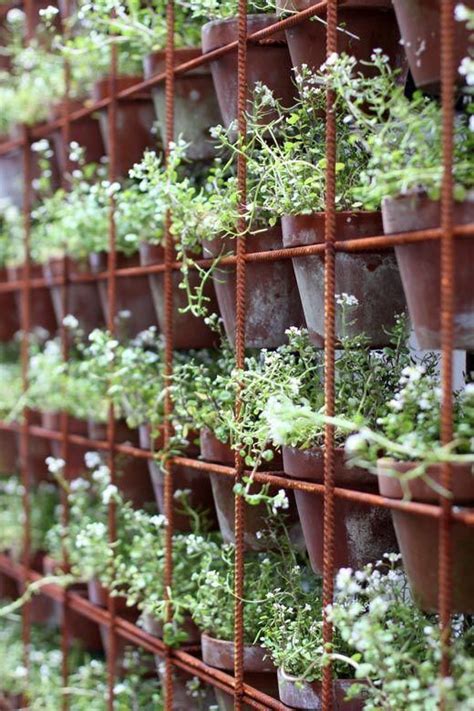 A Very Clever Potted Herb Wall Pots Slotted Into Rusty Steel Rio Mesh