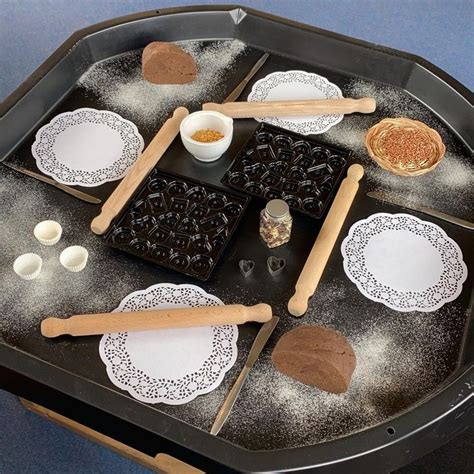 An Assortment Of Baking Utensils Are Arranged On A Black Tray With